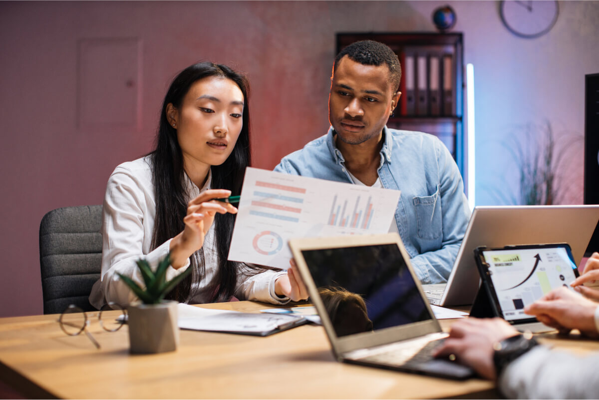 Diverse colleagues collaborating late at a modern office